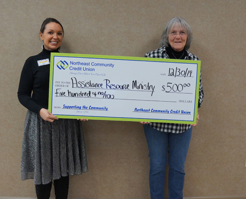 Velda Sizemore, NCCU Member Service Specialist, presents ARM Executive Director Faye Ingram with a donation of $500 for Assistance and Resource Ministries’ programs
